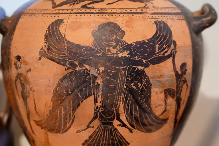 A harpy is depicted on the side of an ancient urn.