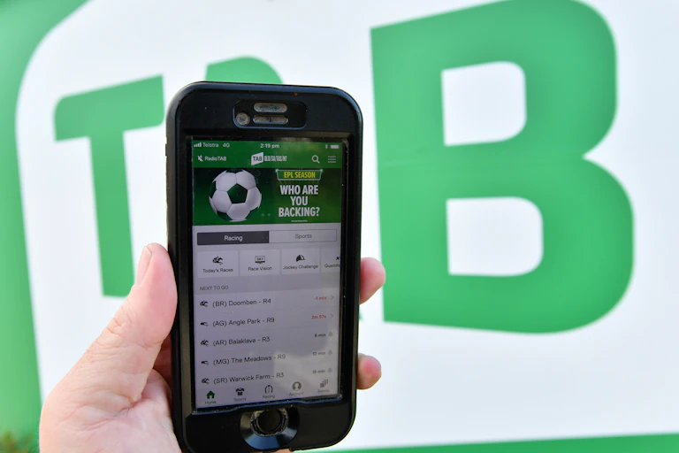 The TAB betting app is seen on a mobile phone outside a Tabcorp venue