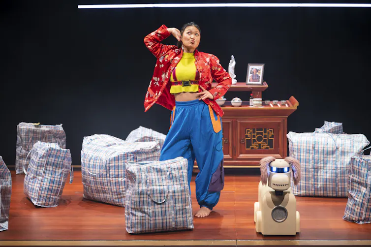 Production image: a woman strikes a silly pose, next to the dog.