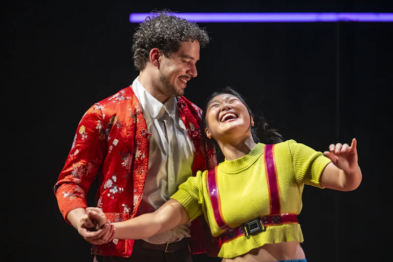 Production image: a young couple laugh together.