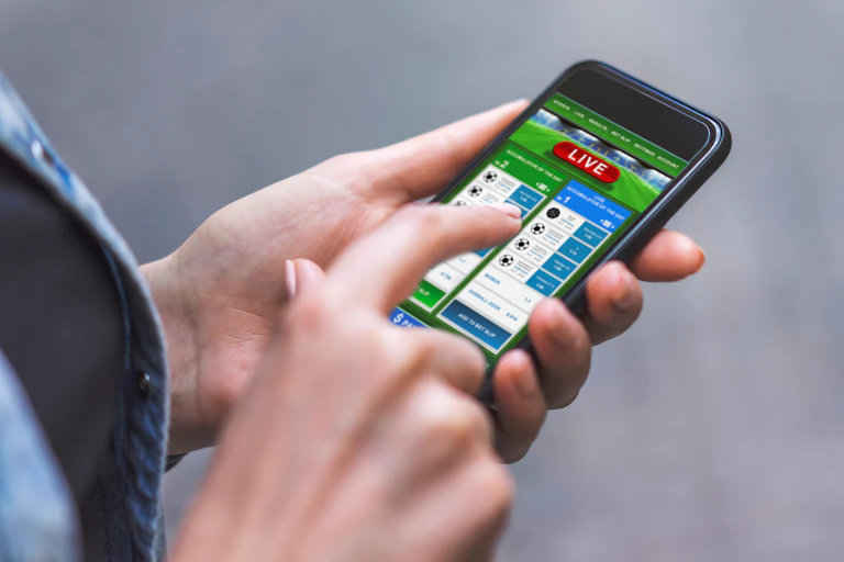 A woman gambles on her phone
