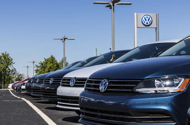 brand new cars lined up at a volkswagen dealership
