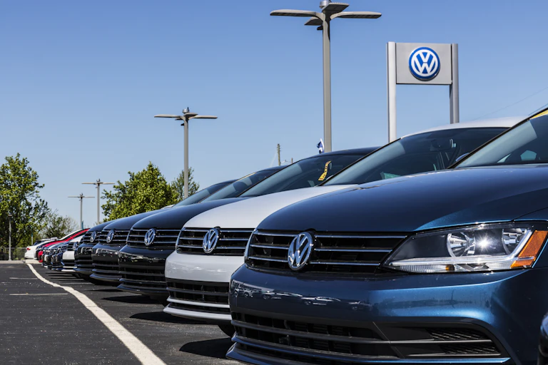 brand new cars lined up at a volkswagen dealership