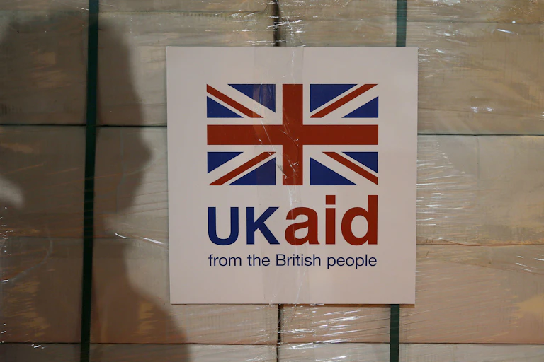 A crate of boxes with a UK Aid sign on them.