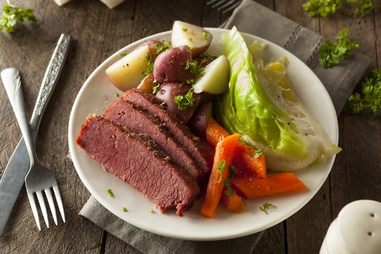A plate of corned beef, cabbage and carrots