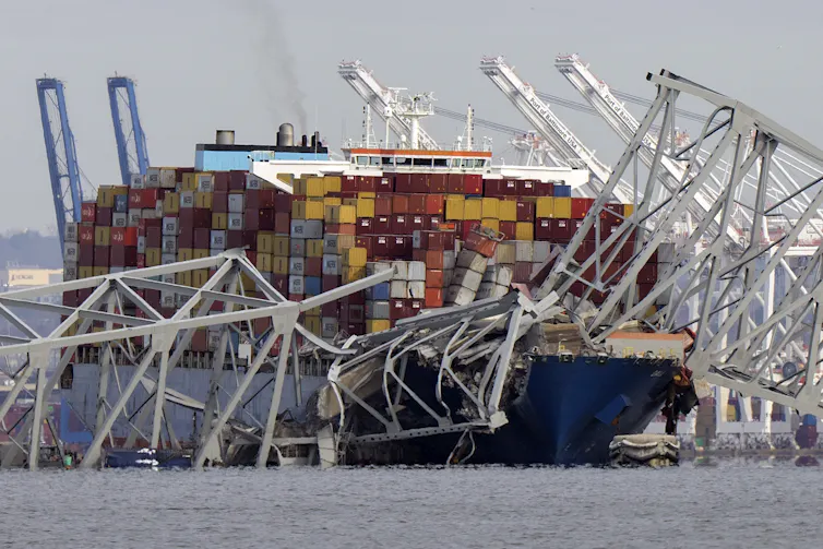 Metal bridge parts rest atop a ship.
