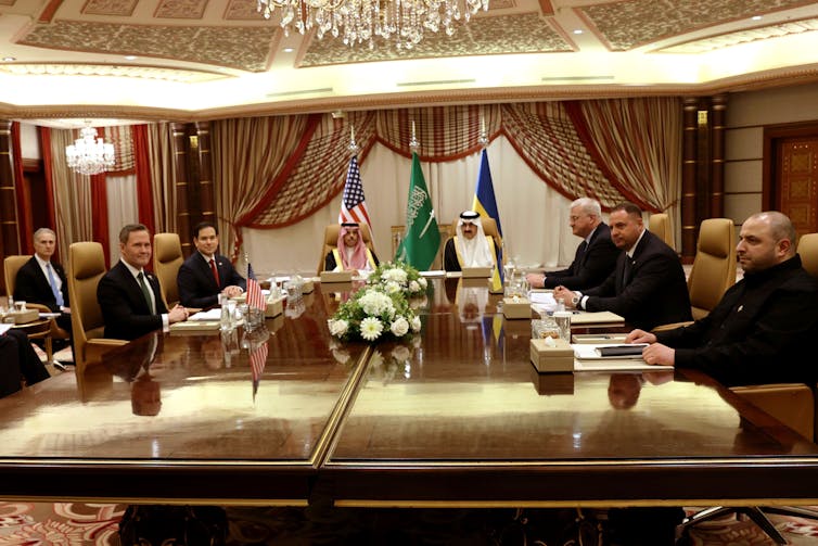 Men sit around a large table.