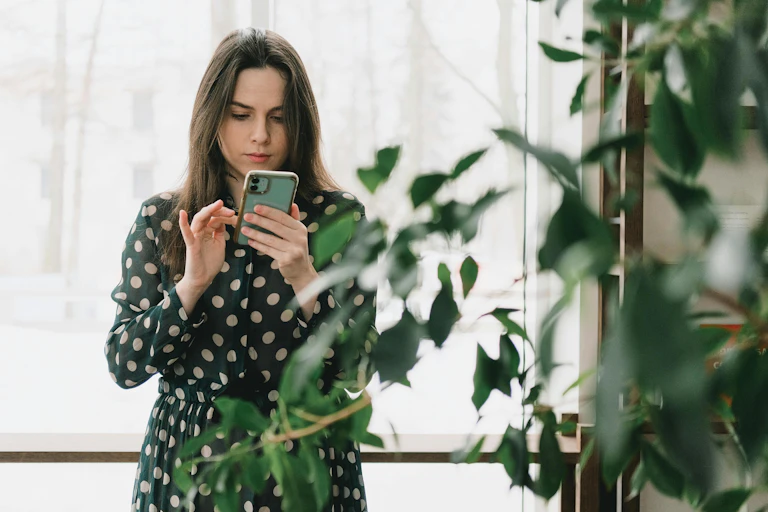 Woman looks intently at her phone