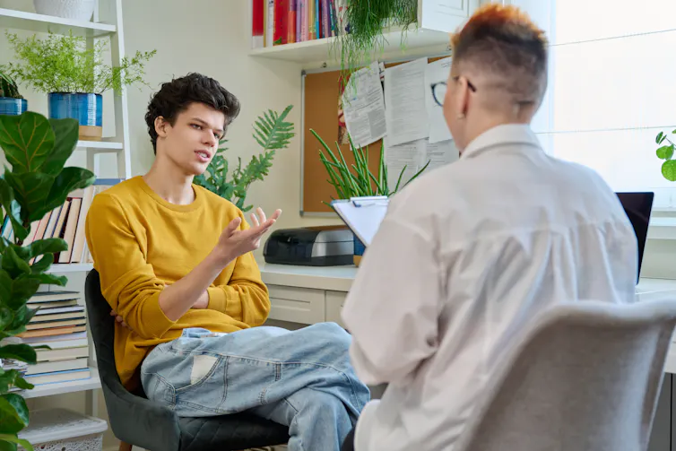 Young man talks to his mental health provider
