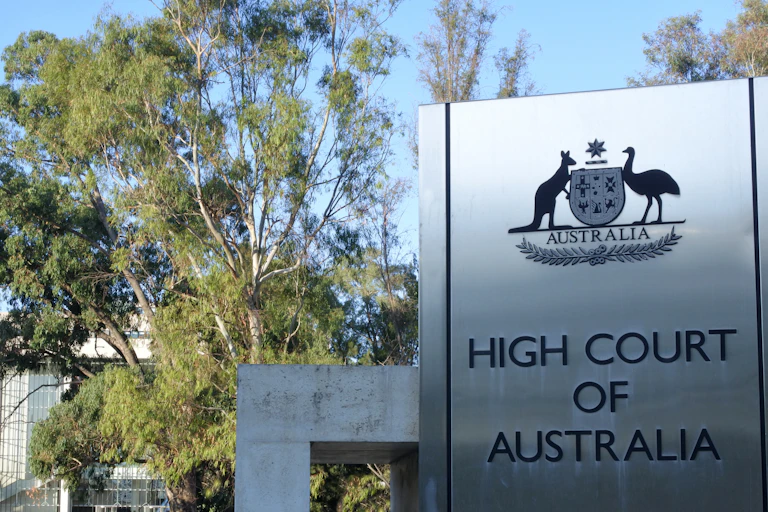 A large silver sign that says High Court of Australia