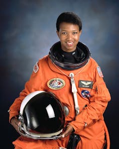 Mae Jemison in an orange astronaut suit