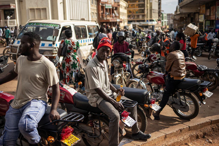 Men seating on motorbikes in a crowded street