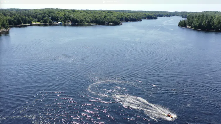 A jet ski generates numerous wakes on a pristine lake