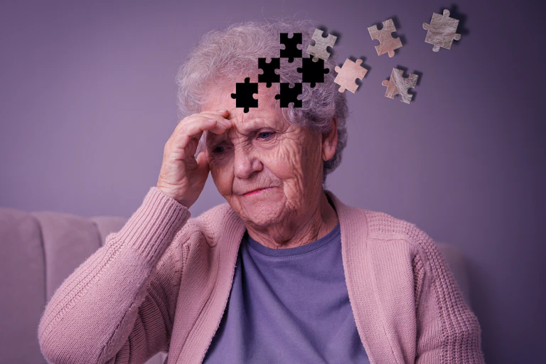 Older woman holding her head, looking troubled