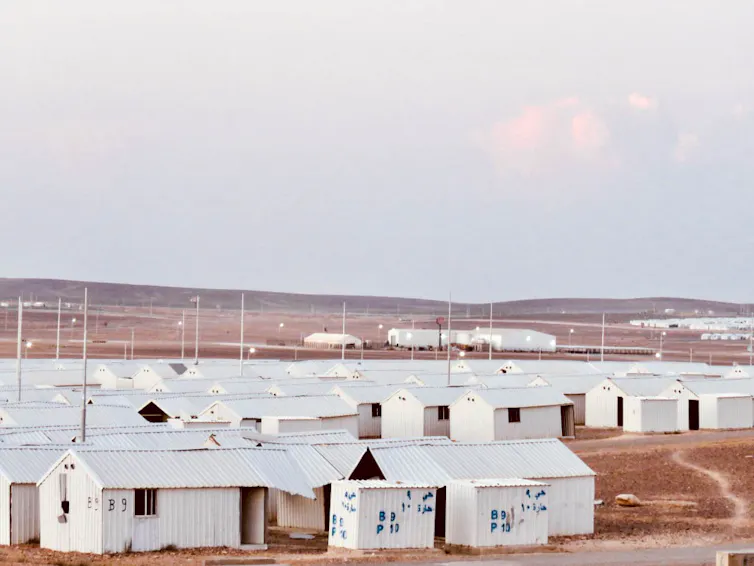 A plot of empty white shelters.