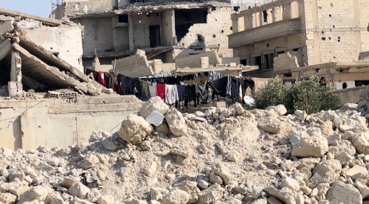 Laundry hung up amid the rubble of a devastated town.