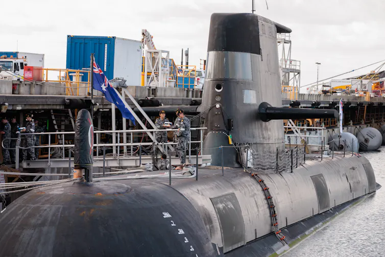 A Collins class submarine docked in port.