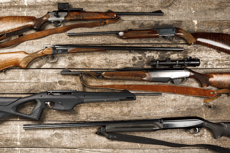 Rifles displayed on wooden boards
