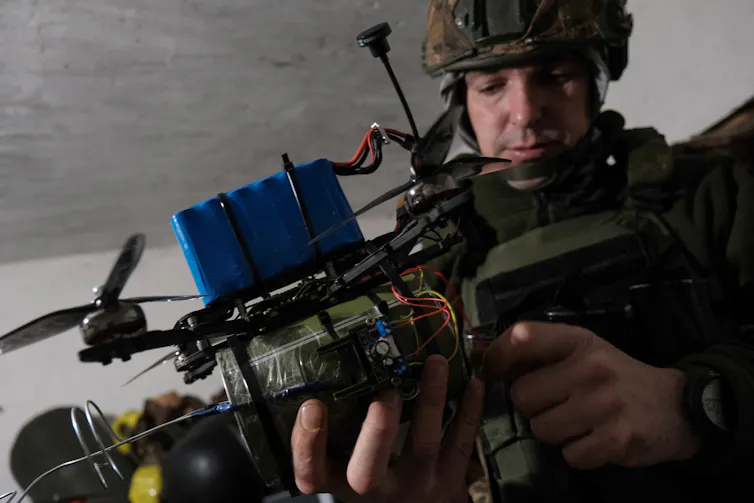 An engineer works on an aerial drone.