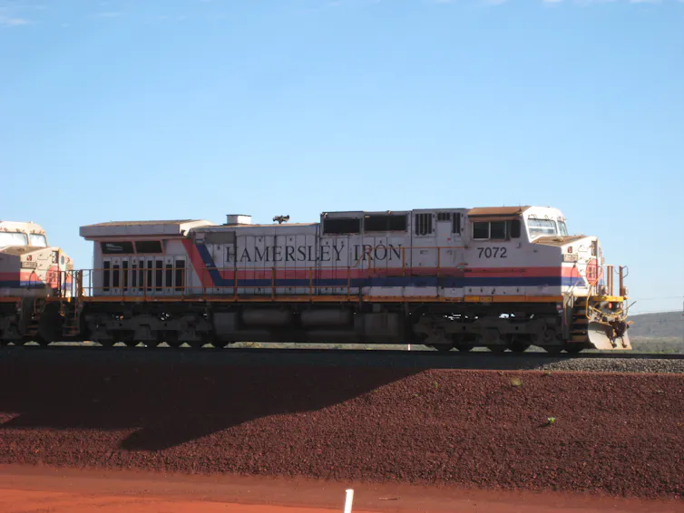 Old photo of a train in the Pilbara with signage Hamersly Iron
