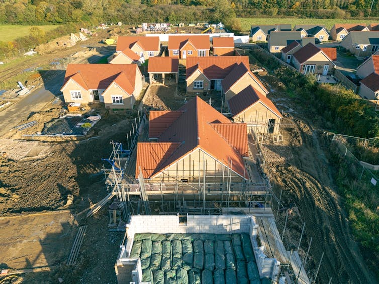 aerial shot of a greenbelt building site of new homes