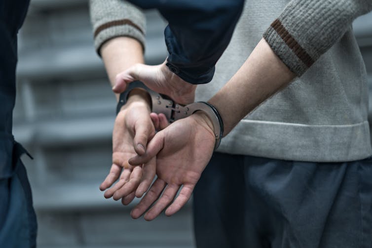 Close up of a man's hands with handcuffs