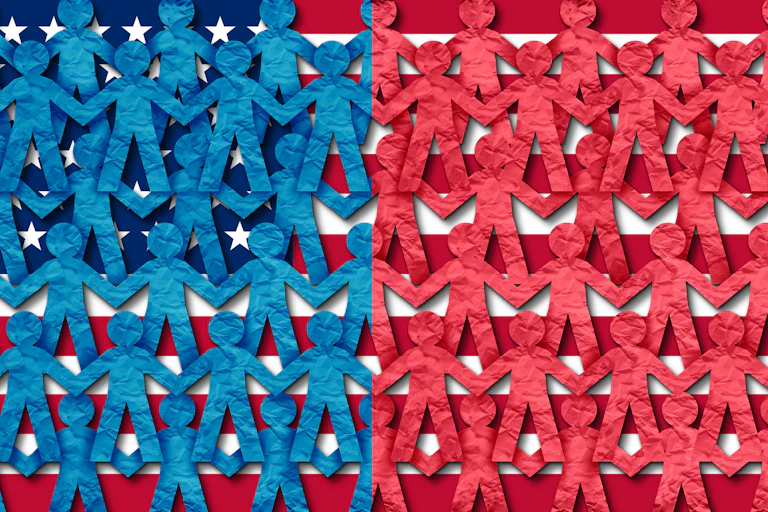 Paper dolls, half of them blue and half of them red, hold hands over an American flag.