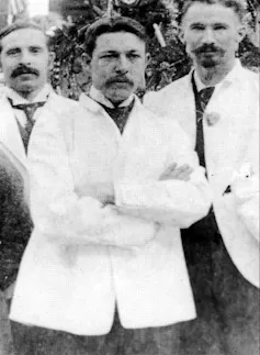 A black and white photograph of William Coley, flanked by colleagues in white coats.