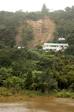 A large landslide threatens houses in the coastal suburb of Muriwai following Cyclone Gabrielle in February 2023.