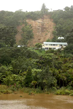 A large landslide threatens houses in the coastal suburb of Muriwai following Cyclone Gabrielle in February 2023.