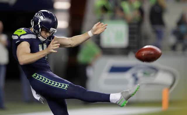 Michael Dickson punts the ball during a 2024 NFL game.
