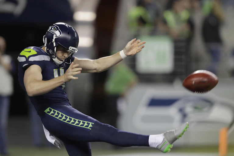 Michael Dickson punts the ball during a 2024 NFL game.