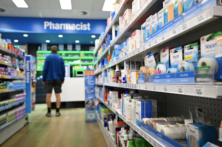 Man stands at pharmacy counter