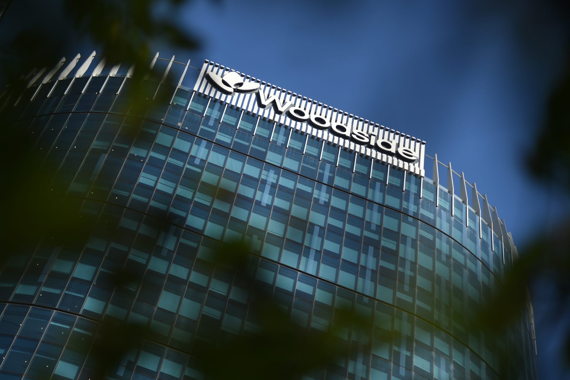 tall office building with sign at top reading 'Woodside'