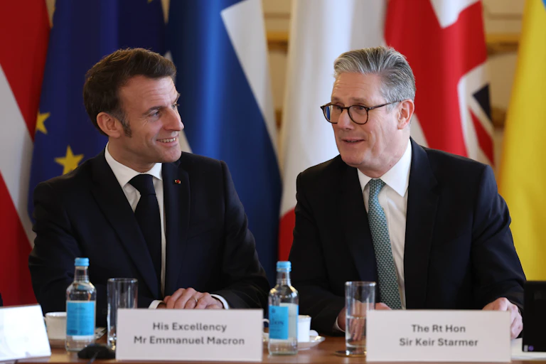 French president, Emmanuel Macron, and UK prime minister, Keir Starmer, smile at each other at a conference in London, March 2025.
