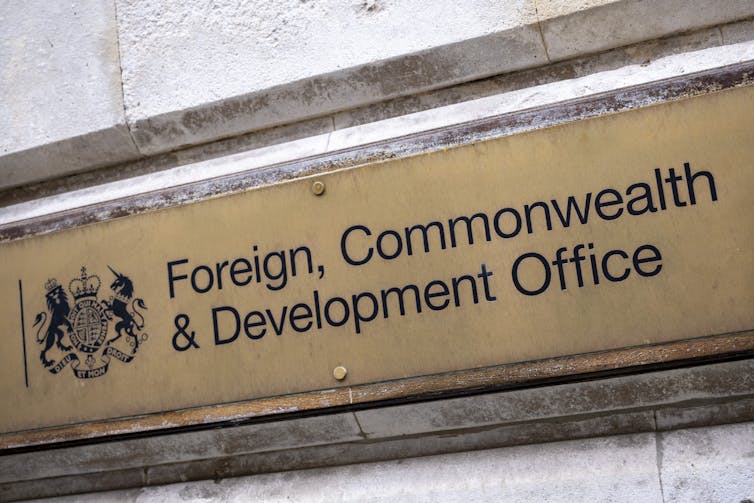 Photo of a gold plaque on a wall reading 'Foreign, Commonwealth & Development Office'