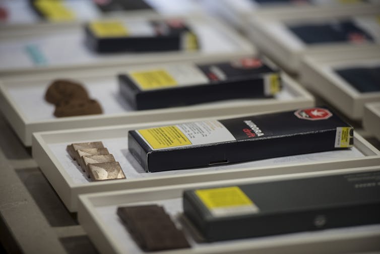 Boxes with yellow warning labels displayed next to different pieces of chocolate