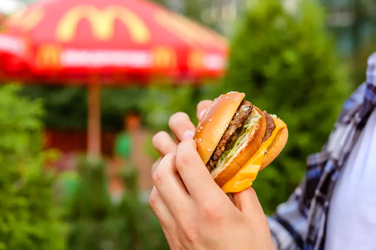 person holding a hamburger