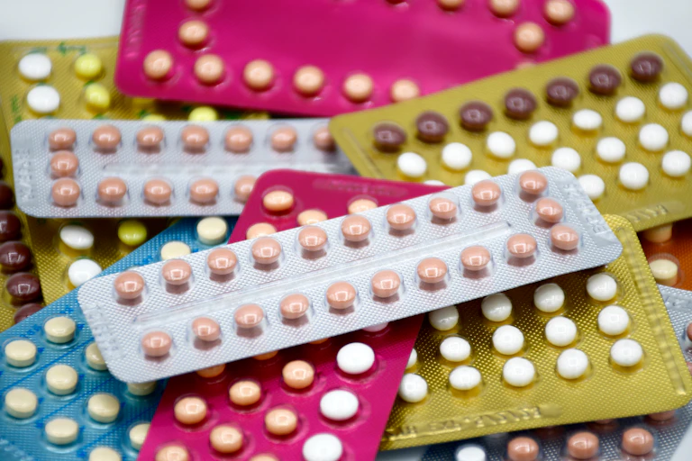 A pile of colourful packs of contraceptive pills.