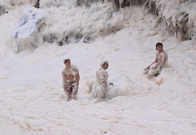 Boys play in sea-foam at Coolangatta on the Gold Coast, Friday, March 7, 2025.