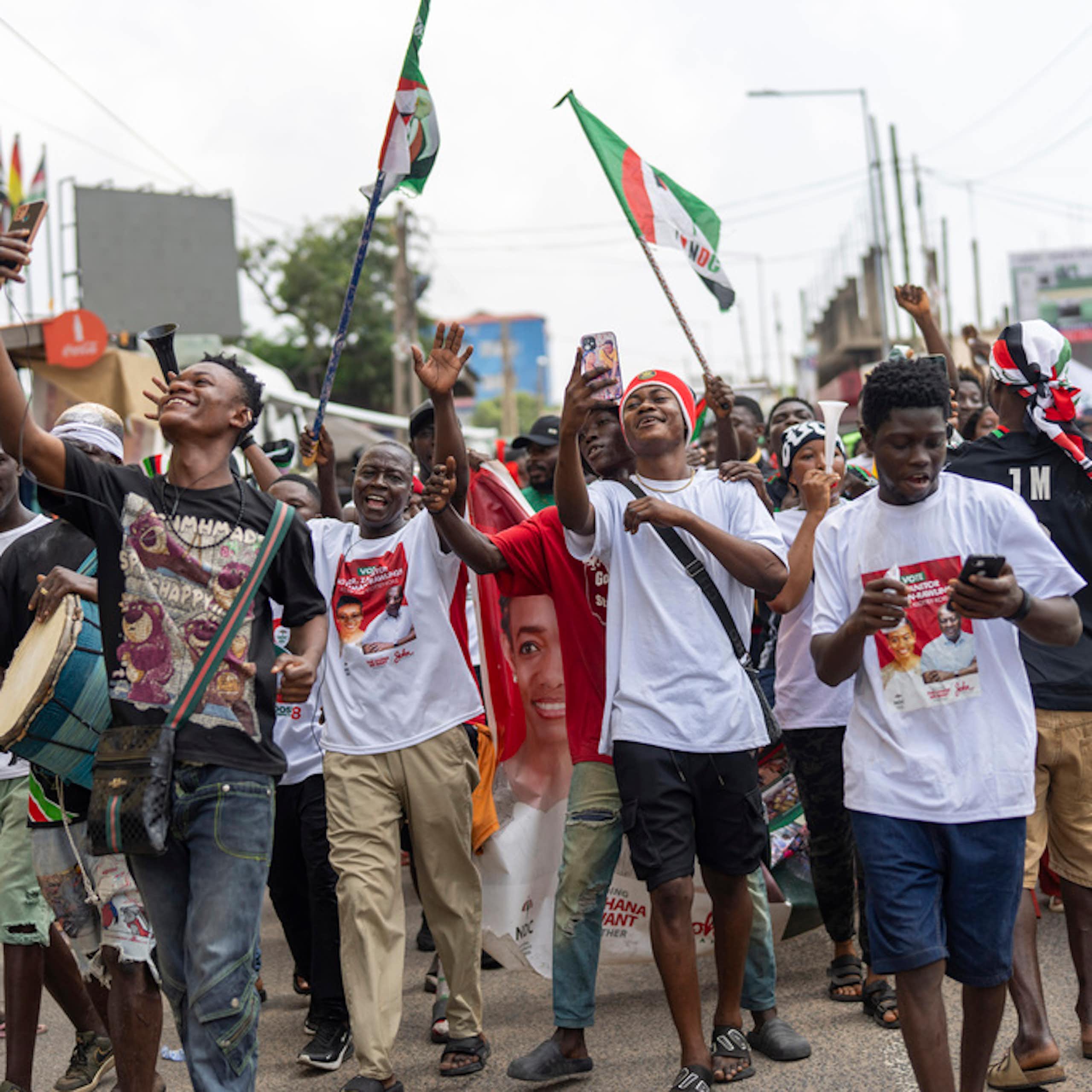 A group of young man celebrate in the street.