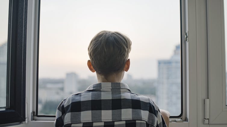 Boy looking out of window
