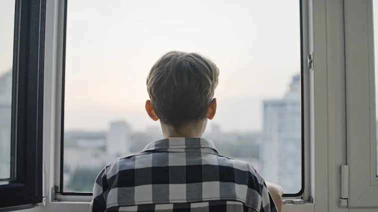 Boy looking out of window