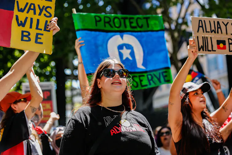 A young Indigenous woman marches in a protest