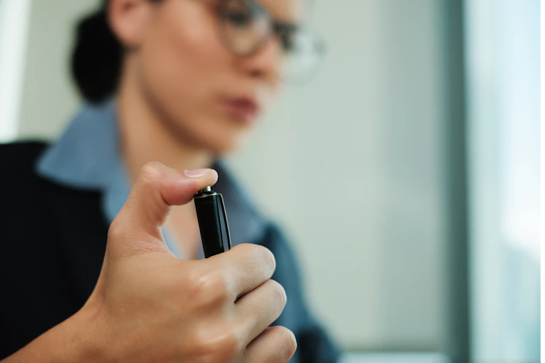 A woman clicks on her pen button.