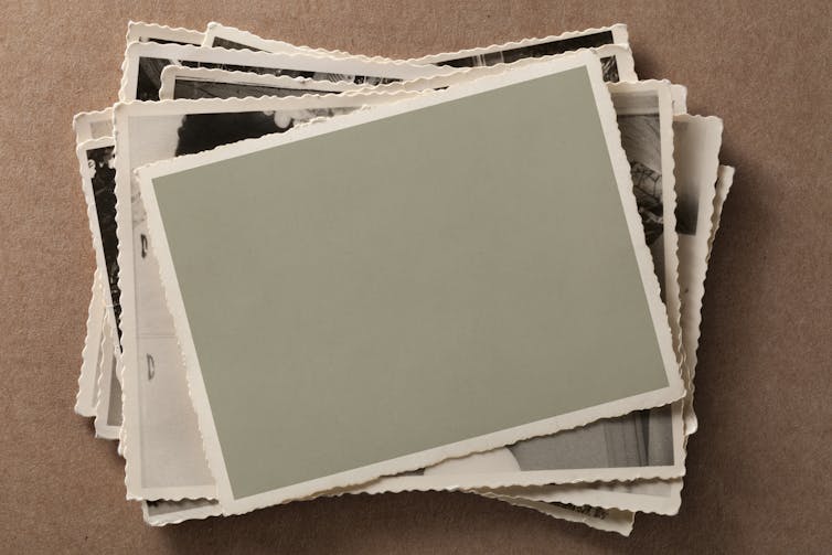 blank photo atop a stack of old black and white pictures