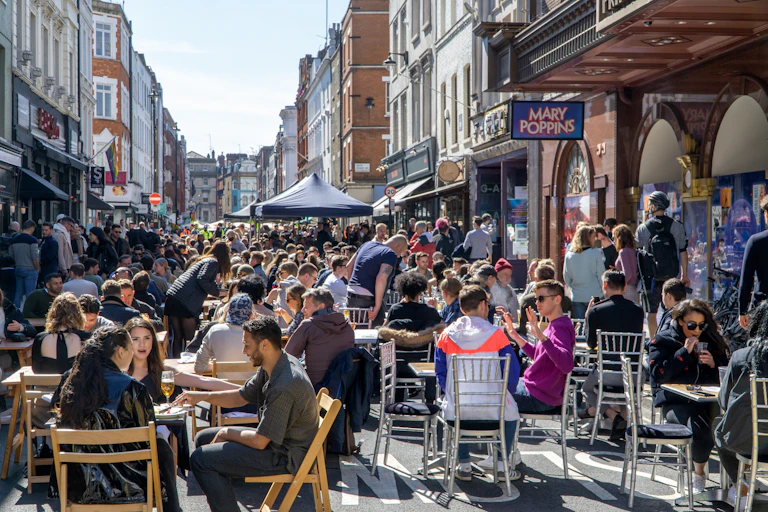 Outdoor diners in a city street.