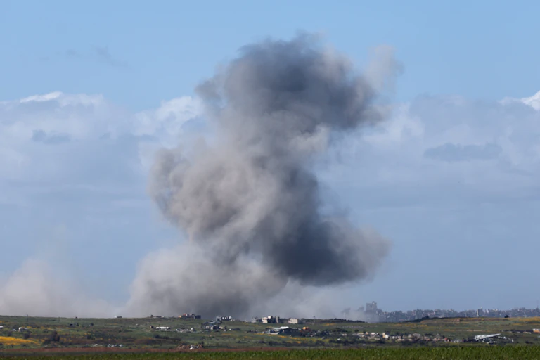 A plume of black and grey smoke is seen with distances in the foreground.