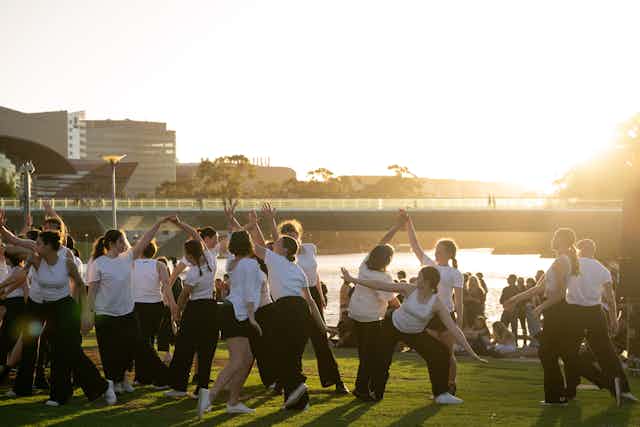 Dancers in front of a sunset.