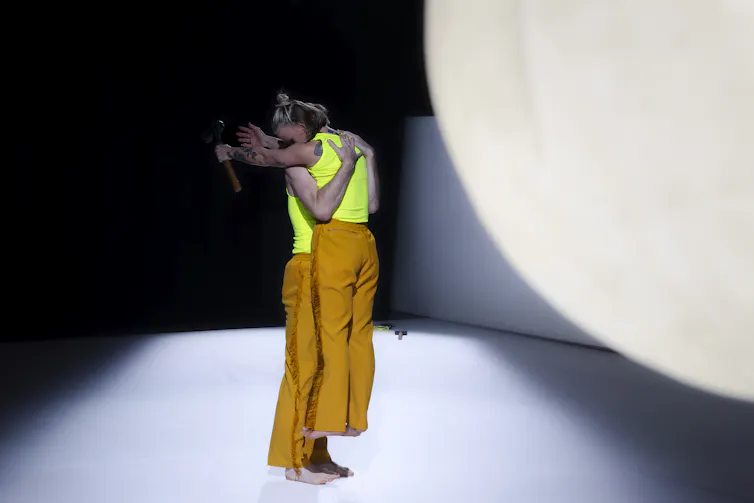 Two dancers embrace.
